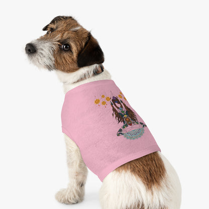 Dog wearing a pink sweater with a printed design on a white background