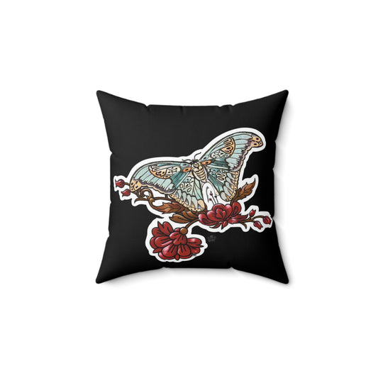Black pillow with a butterfly and floral design on a white background