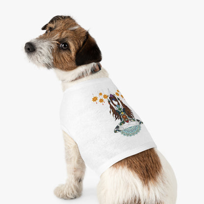Dog wearing a white t-shirt with a printed design on a white background