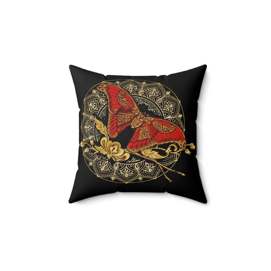 Decorative pillow with a red and gold butterfly design on a black background