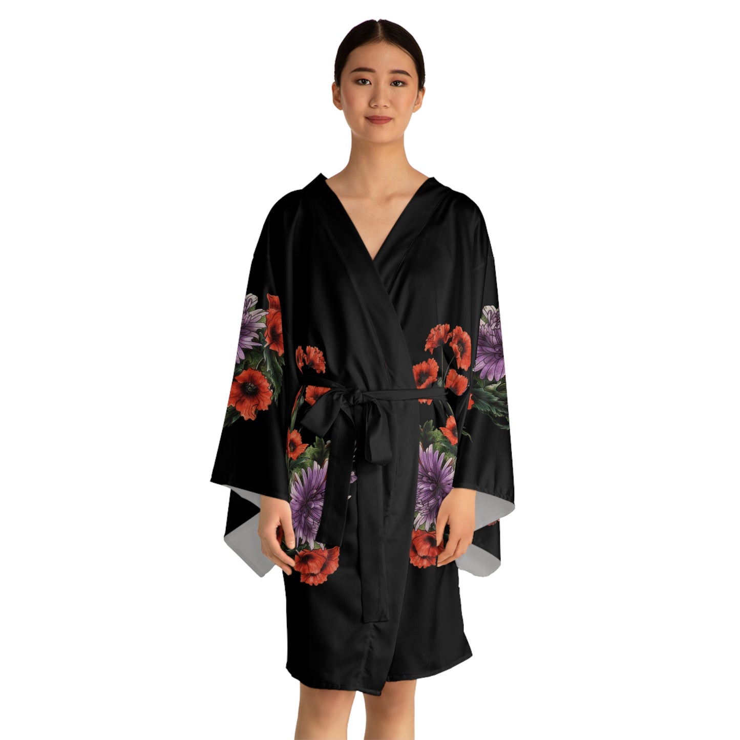 Woman wearing a black robe with floral patterns on a white background