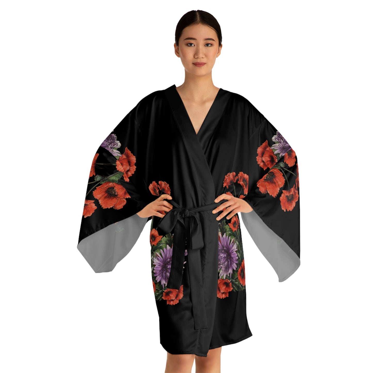 Woman wearing a black floral kimono-style garment on a white background